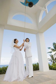 男女礼服握着钟绳穿着婚纱和礼服的男女图片图片